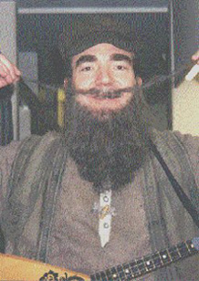 Andy wih fake beard, moustache, and balalaika. At National Theatre.